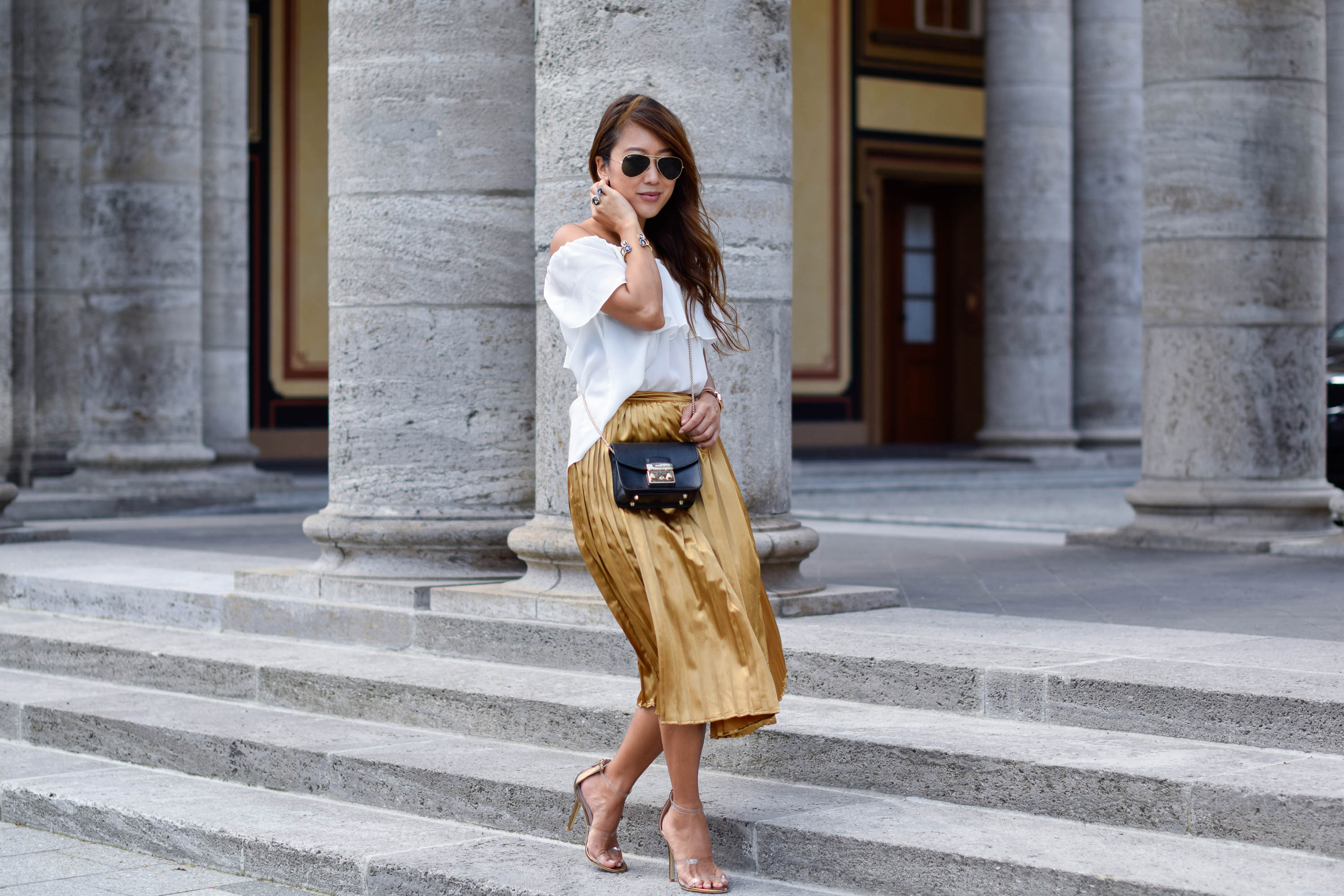 Gold pleated skirt and white blouse The Classy Cloud